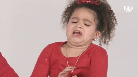 Video gif. A curly-haired little girl leans away from something she clearly thinks is gross.