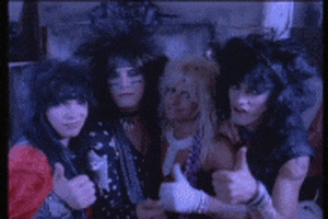 Music video gif. From Motley Crue’s Smokin' in the Boys Room video, the band smiles and nods and gives us a thumbs up as if to say, “Good job.”
