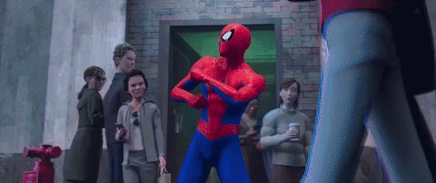 Video game gif. Spider-Man dances, shaking his hips and twirling his wrists around each other, as people walk in and out of a doorway glancing at him.