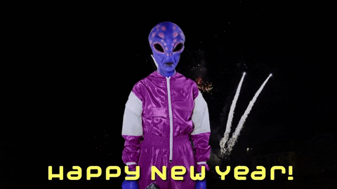 Video gif. Someone dressed as a purple and pink spotted alien in a purple track suit shoots a laser gun in a cloud of confetti and fireworks. Text, "Happy New Year!"