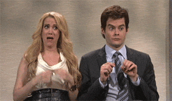 SNL gif. Kristen Wiig and Bill Hader are standing next to each other and make suggestive hand motions. Bill puts one finger into the other hand that's making an O shape and Kristen dances while mimicking opening her blouse.