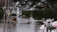 Man Uses Kayak to Traverse Flooded Streets in Quebec Village