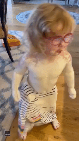 Toddler Waddles Into Kitchen Wearing 'Penguin Dress' Made With Diaper Cream