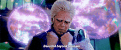 Movie gif. Benicio del Toro as The Collector in Guardians of the Galaxy knocks his fists together and busts them open, like an explosion. Text, "Beautiful beyond compare."