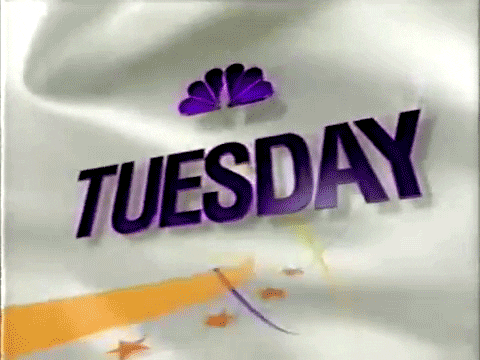 Text gif. Purple NBC logo over the text. There are stars and yellow, purple streaks moving around the background. Text, “Tuesday.”