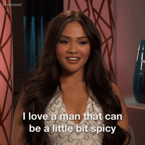TV gif. Bachelorette Jenn Tran maintains a confident demeanor, smiles and blinks slowly while saying "I love a man that can be a bit spicy."