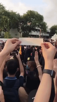 Protesters Flash Three-Fingered Salute at Royal Motorcade in Bangkok, Thailand