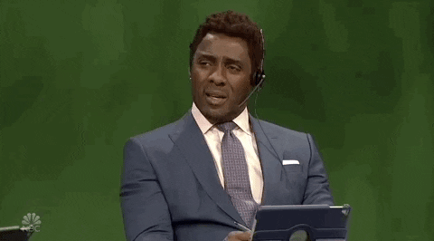 SNL gif. Wearing a headset and appearing as an announcer, Idris Elba nods his head and glances offscreen, saying, "Yeah." His name and title flash across the screen, "Dave 'The Bruiser' Koosman."