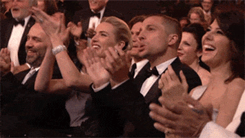 Video gif. An audience at an awards show cheer and whoop as they celebrate somebody's win. They begin to stand up in unison, agreeing with chosen recipient. 