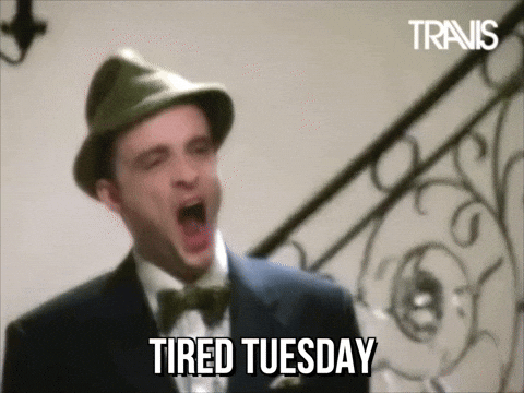 Celebrity gif. Singer Fran Healy of the band Travis yawns deep in a green wool hat. Text, "Tired Tuesday."