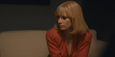 Movie gif. Jessica Chastain as Anna in A Most Violent Year. She's on the couch upset and she lifts a hand to ask us to stop as she gathers herself.