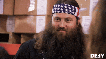Reality TV gif. Willie Robertson on Duck Dynasty looks around with a satisfied smile and nods his head.