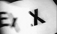 Video gif. Black and white footage of book pages being flipped through rapidly, each page printed with large black letters, "Sex."