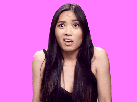 Video gif. A woman with long black hair bends her arms and raises her palms in the "I dunno!" motion, shaking her head and looking around. She really has no idea what's going on.