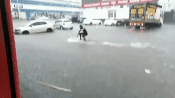 Surfer Takes to Flooded Streets as Storm Hits Durban