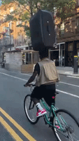 Brooklyn Cyclist Balances Suitcase on His Head