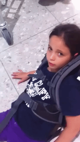 Heavy Luggage Prevents Girl From Standing Up