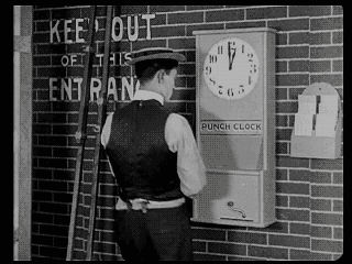 Movie gif. Buster Keaton in The Play House approaches and quickly examines a clock labeled, "Punch clock" on a brick wall that has text reading, "Keep out of this entrance" painted upon it. He takes one swing at the clock, and its paper face easily folds in. Satisfied, he grabs his shotgun and struts away.