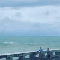 Large Waves Drench Kids on Pier as Tropical Storm Elsa Approaches Florida