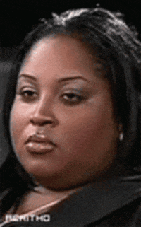 Reality TV gif. Tanisha on Bad Girls Club listens to something and begins to shake her head discreetly, trying not to smile at a ridiculous comment, and then rolls her eyes.