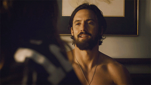 TV gif. Milo Ventimiglia as Jack Pearson from This Is Us stands shirtless and gives a high five to a character in the foreground, clasping their hand and giving them a quick wink.