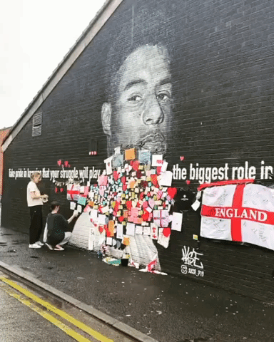Flags and Messages of Support Posted on Defaced Rashford Mural in Manchester