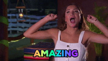 Reality TV gif. Nicole Lopez-Alvar talking head from Bachelor in Paradise, arms up, flicking her fingers out like popcorn popping as she says, "Amazing."