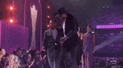 TV gif. Band members of the band Old Dominion strutting off stage after receiving their award.