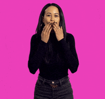 Video gif. A woman dressed in black blows us a big kiss using both hands.