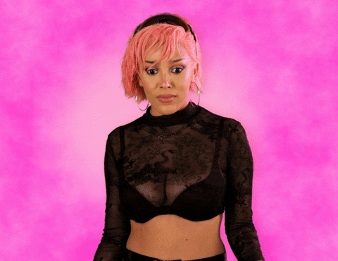Celebrity gif. Doja Cat puts both hands on her shoulders and leans back, staring at us with wide eyes while opening her mouth and gasping. She looks at us up and down and is impressed with what she sees.