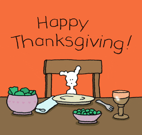 Cartoon gif. Chippy the dog sits at a table with plates of food. Chippy waves and holds up a sign that says, "Pass the bones." Text above him says, "Happy Thanksgiving!"