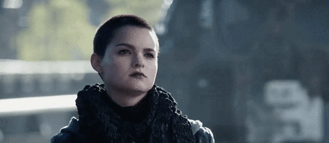 Movie gif. Brianna Hildebrand as Negasonic Teenage Warhead in Deadpool shrugs and shakes her head indifferently, and her face shows a cold, stoic expression.