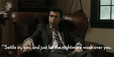 TV gif. Sitting in a rich leather armchair, Alex Karpovsky as Ray in Girls flips his hands up and nods his head while saying, "Settle in, son, and just let the nightmare wash over you," which appears as text.