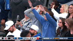 Video gif. Dallas Mavericks holds his hands up and does a big exaggerated bow next to another who has his hands behind his head looking frozen in shock. 
