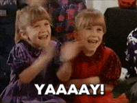Movie gif. Mary Kate Olsen as Kelly and Ashley Olsen as Llynn in Double Double Toil and Trouble clap their little hands excitedly. Text, "Yay!"