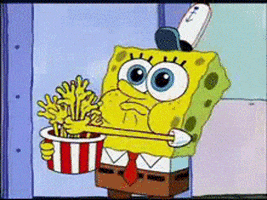 SpongeBob gif. Spongebob crams yellow hands that rest in a popcorn bowl into his mouth. 