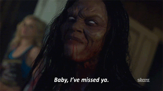 TV gif. Jill Marie Jones as Amanda Fisher on Ash vs Evil Dead, her hair matted, her face covered in blood, her eyes whited out, smiling devilishly as she says "Baby, I've missed ya," which appears as text.