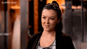 Reality TV gif. A contestant on Blown Away looks happy as she cheekily says, "Good," during an interview.
