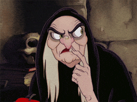 Disney gif. The Evil Queen from Snow White and the Seven Dwarves looks at us with a creepy, evil smile. She has her finger to her lips and she slowly looks left to right.