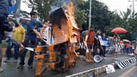Demonstrators Burn Effigy at Protest Against Presidential Bid by Son of Former Dictator