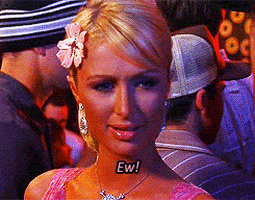 Celebrity gif. Paris Hilton stares at something before determining her disgust, saying, "Ew."