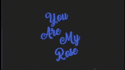 Celebrity gif. Wearing sunglasses and a suit vest, actor Tommy Wiseau emerges beneath the message, “You are my rose,” twirling a rose in his hands, then sniffing it.