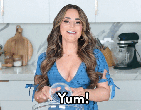 Video gif. Rosanna Pansino smiles as she overturns a small glass bowl into a larger one and says, "yum!"