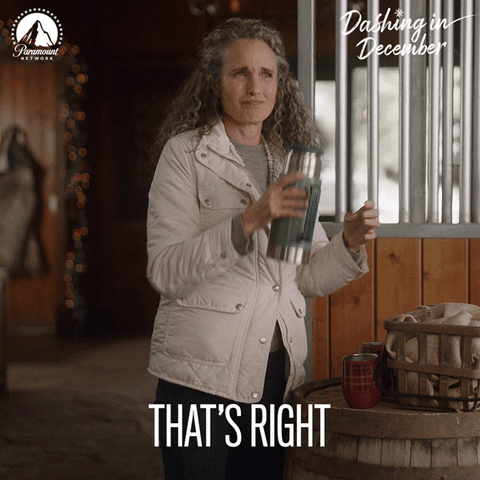 Movie gif. Andie MacDowell as Deb in Dashing In December is in a barn wearing a coat. She raises her thermos to someone with a little nod, saying, "That's right."