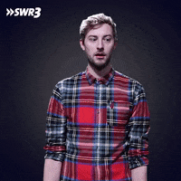 Video gif. Man has a realization and he looks around frantically before clutching his head.