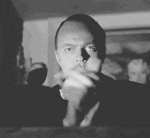 Movie gif. Orson Welles as Charles Foster Kane in Citizen Kane has a serious, almost angry expression on his face as he firmly claps his hands. 
