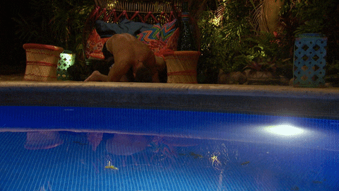 Reality TV gif. Chad on Bachelor in Paradise is so drunk that he slowly collapses onto the ground next to the pool. 