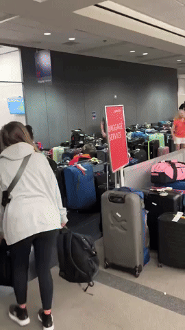 Baggage Claim Overrun With Luggage Amid Delta Flight Cancellations