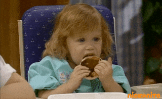 TV gif. One of the Olsen twins, as Michelle on Full House, licks a pancake she's holding and then looks up with disgust.