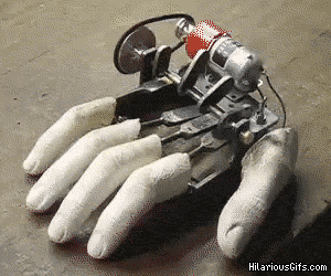 Video gif. A robotic hand with the top exposed is tapping its fingers on a table. We see each gear move smoothly as it controls each finger as it taps, one by one.
